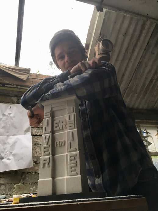 Taff's Well stonemason and carver Josh Underwood takes a break from his Portland stone made reproduction of the Walnut Tree Viaduct tower.